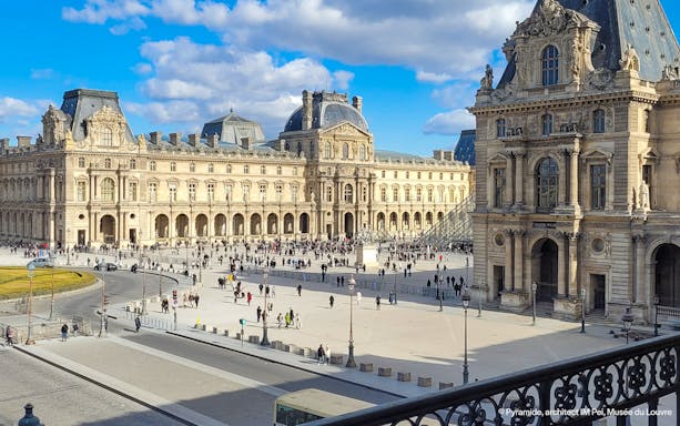 Louvre Museum exterior with courtyard and glass pyramid in Paris.