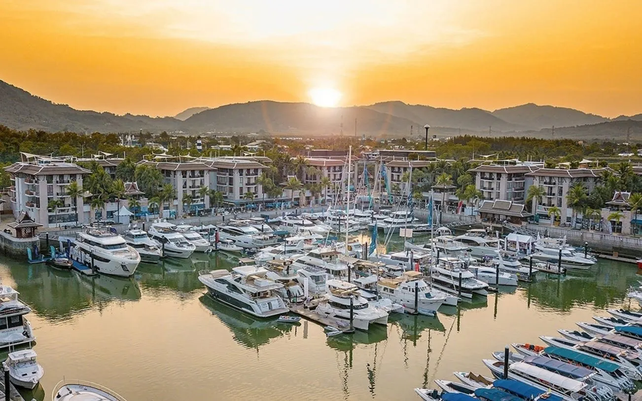 Speedboats docked at Royal Phuket Marina at sunset, departure point for James Bond Island tour.