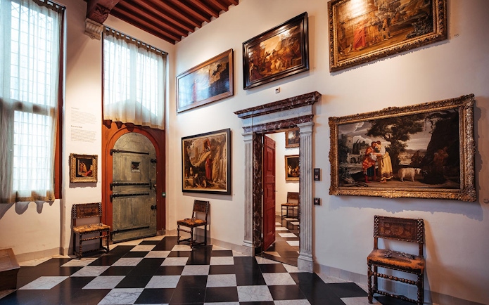 Paintings displayed in a room at the Rembrandt House Museum, Amsterdam.