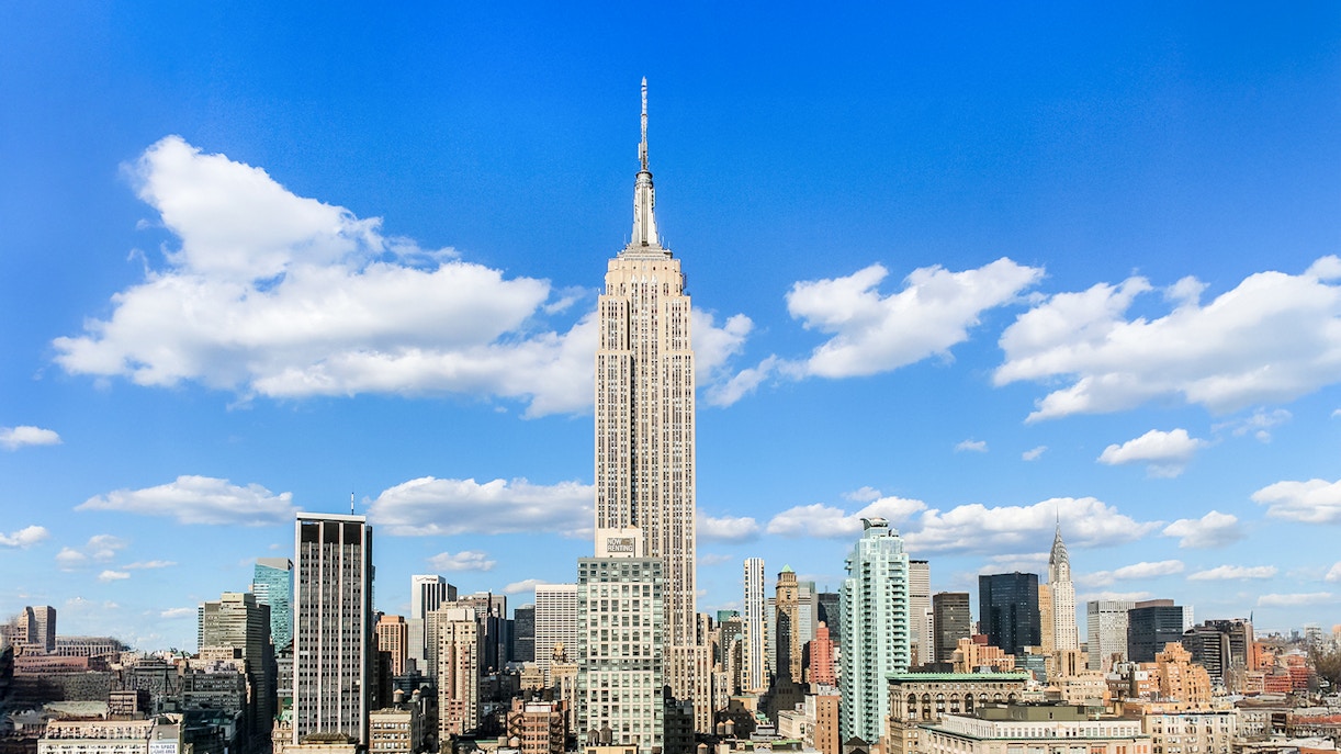 Empire State Building under a clear blue sky in Manhattan, NYC.