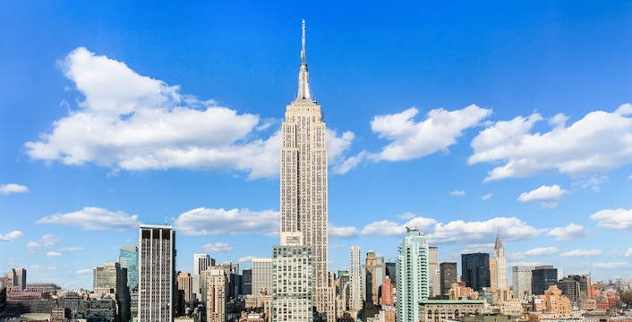 Empire State Building under a clear blue sky in Manhattan, NYC.