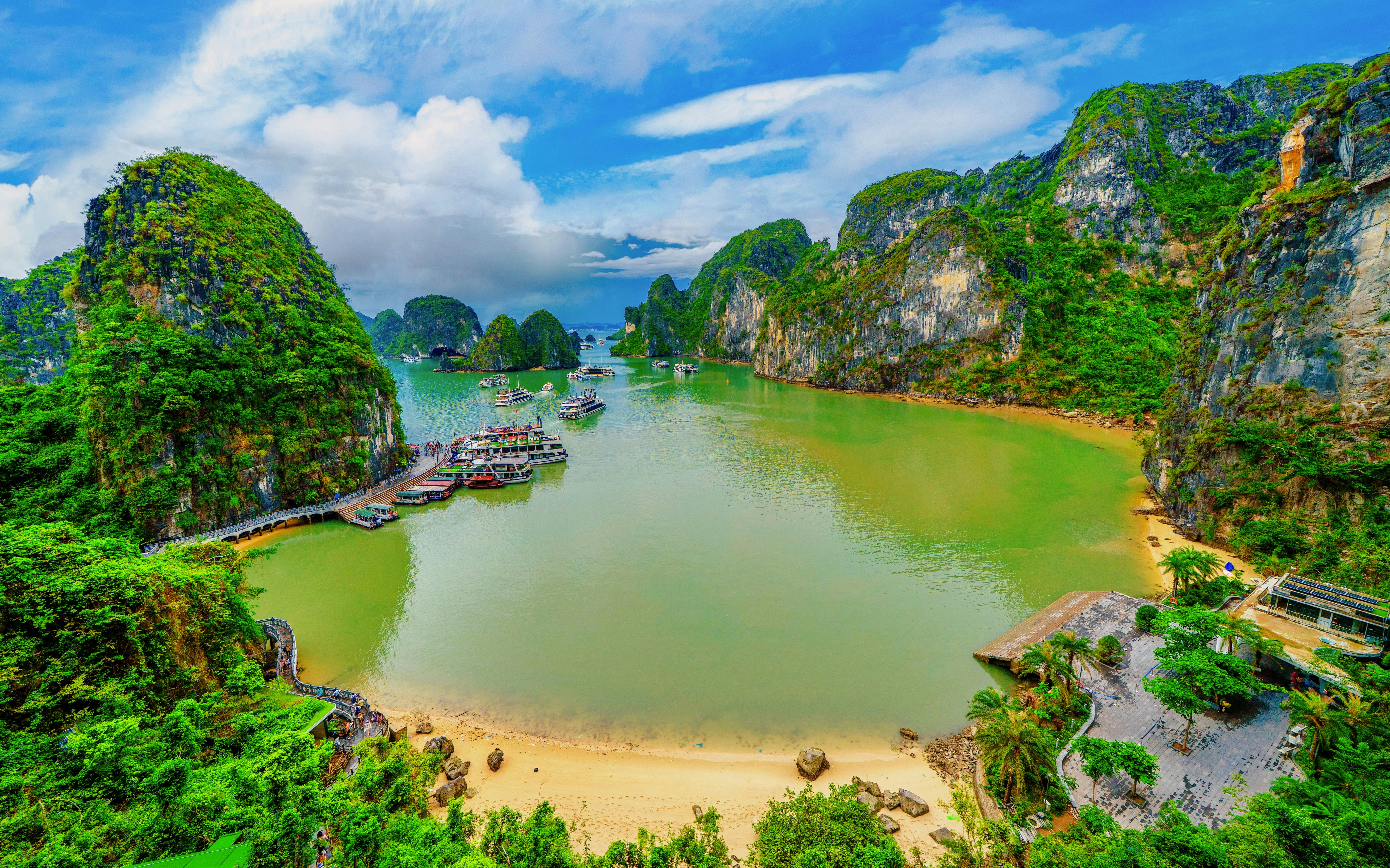 Panoramic view of Ha Long Bay with boats and limestone cliffs from Sung Sot cave viewpoint, Vietnam.
