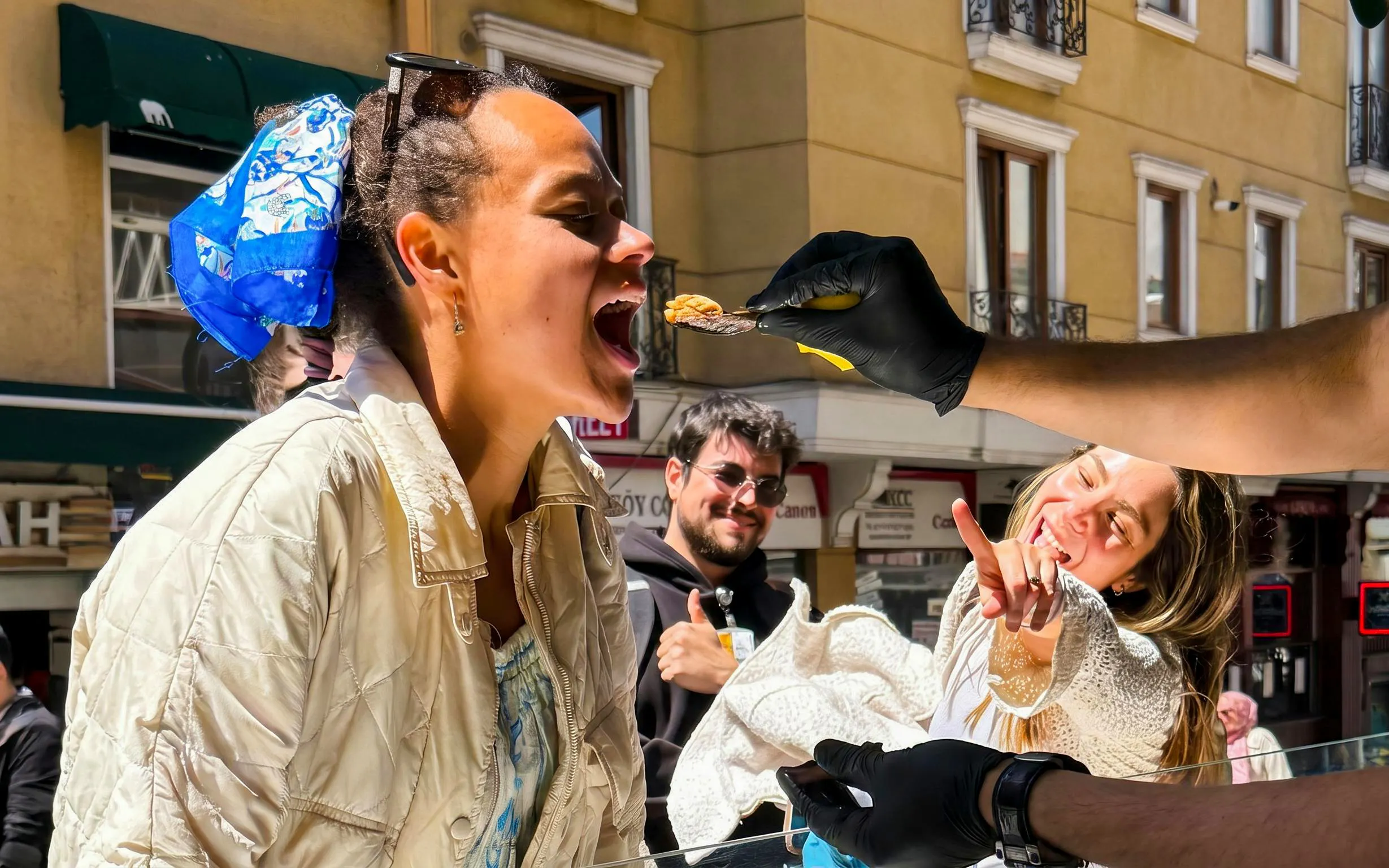 Person tasting local food on Istanbul street during a guided food tour.