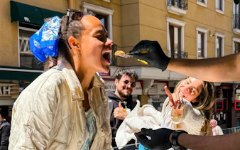 Person tasting local food on Istanbul street during a guided food tour.