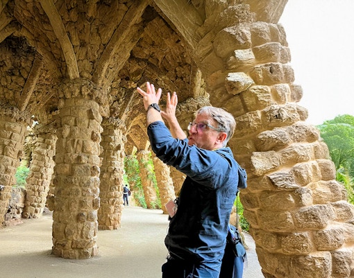 Park Guell mosaic benches and architecture on guided tour, Barcelona, Spain.
