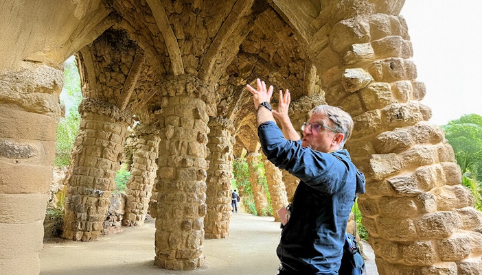Park Guell mosaic benches and architecture on guided tour, Barcelona, Spain.