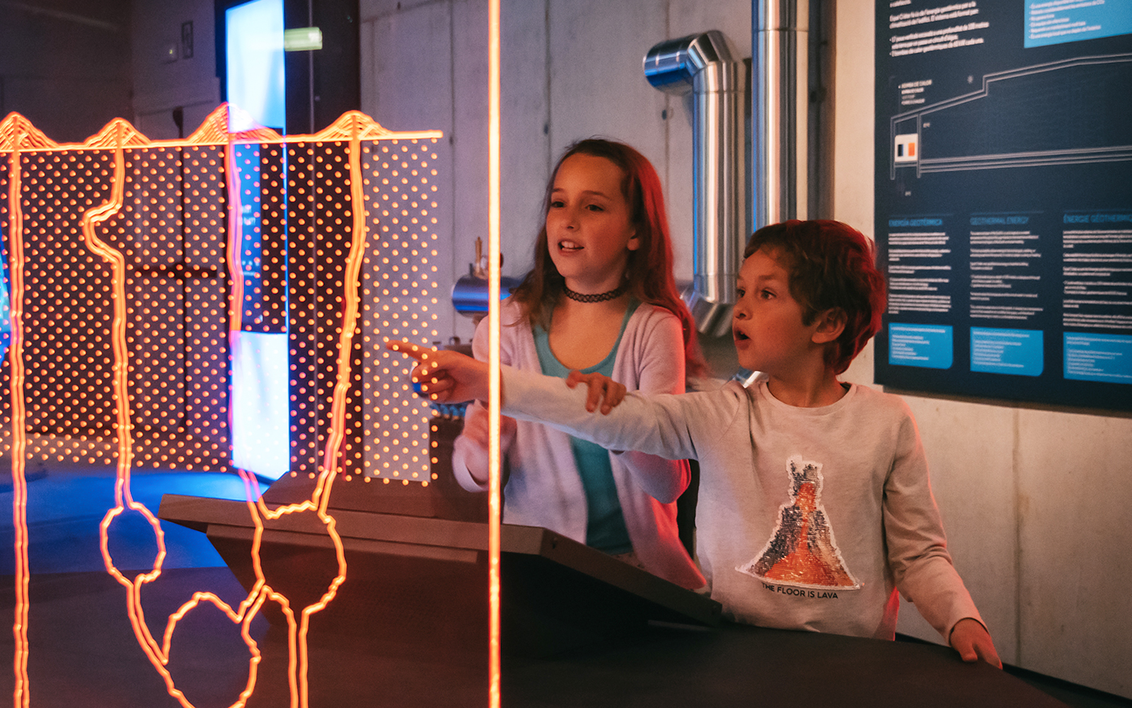 Visitors interacting with a display at Espai Crater.