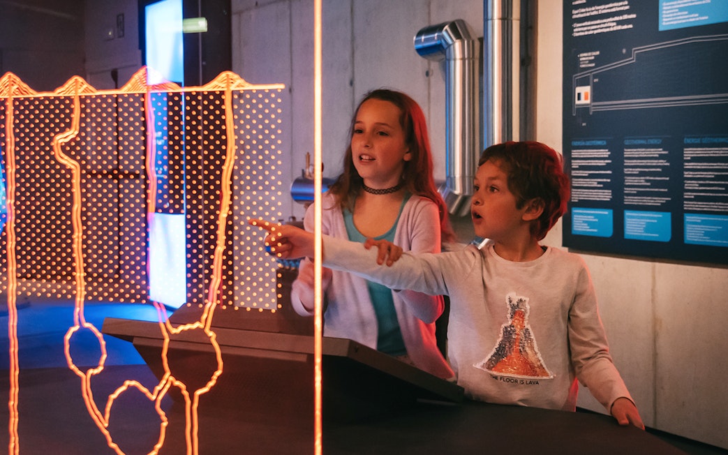 Visitors interacting with a display at Espai Crater.