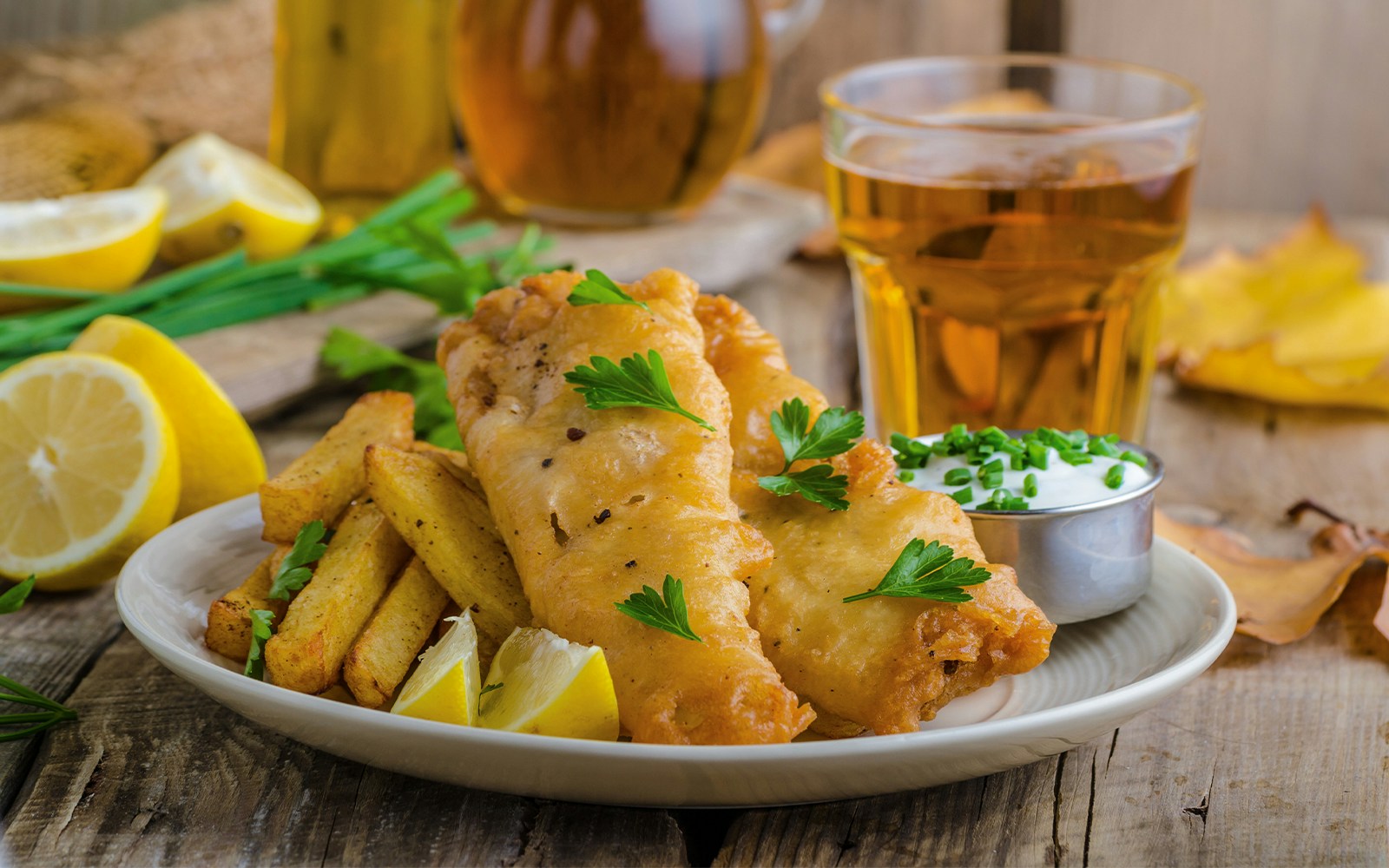 Traditional British fish and chips served on a wooden board in London, England.