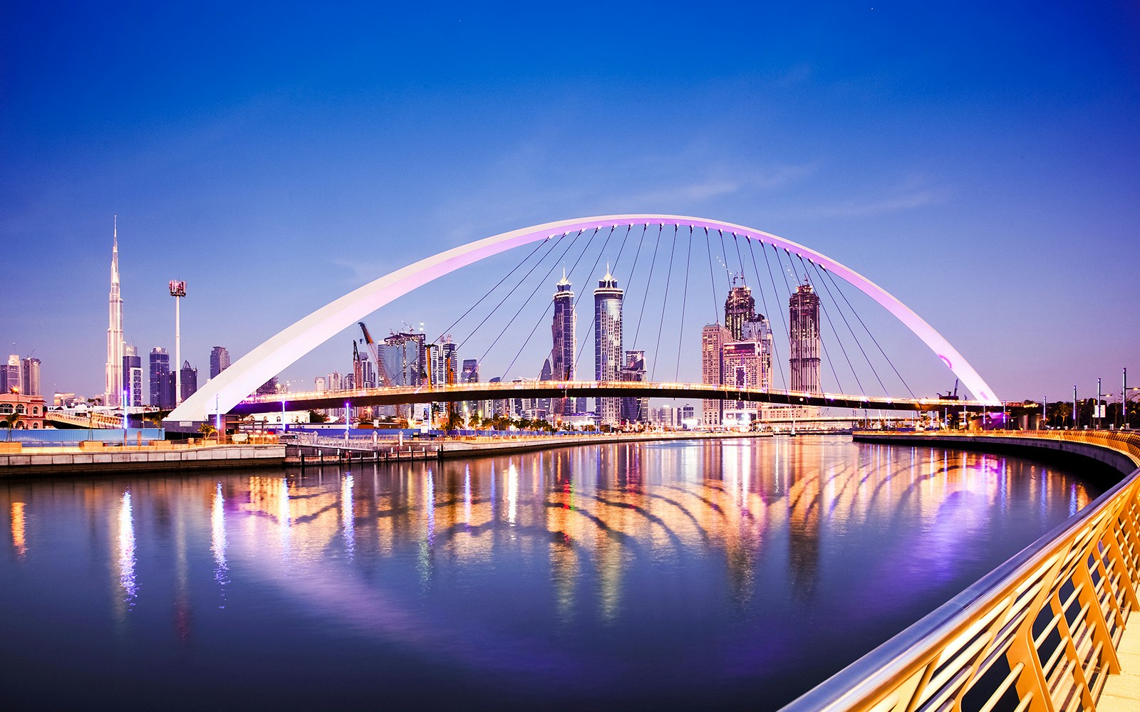Tolerance Bridge over Dubai Water Canal with Dubai skyline in the background.
