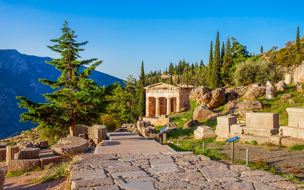 Ancient ruins and temple at Delphi archaeological site, Greece.