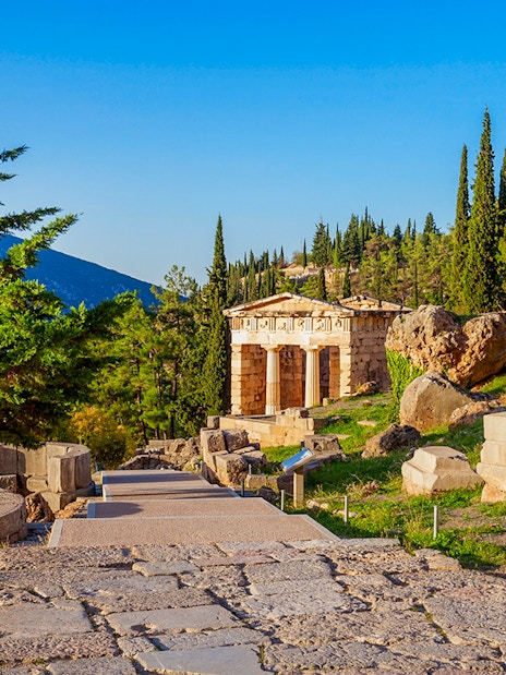 Ancient ruins and temple at Delphi archaeological site, Greece.
