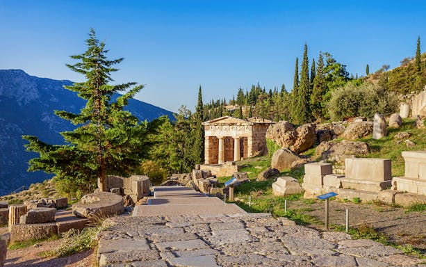 Ancient ruins and temple at Delphi archaeological site, Greece.
