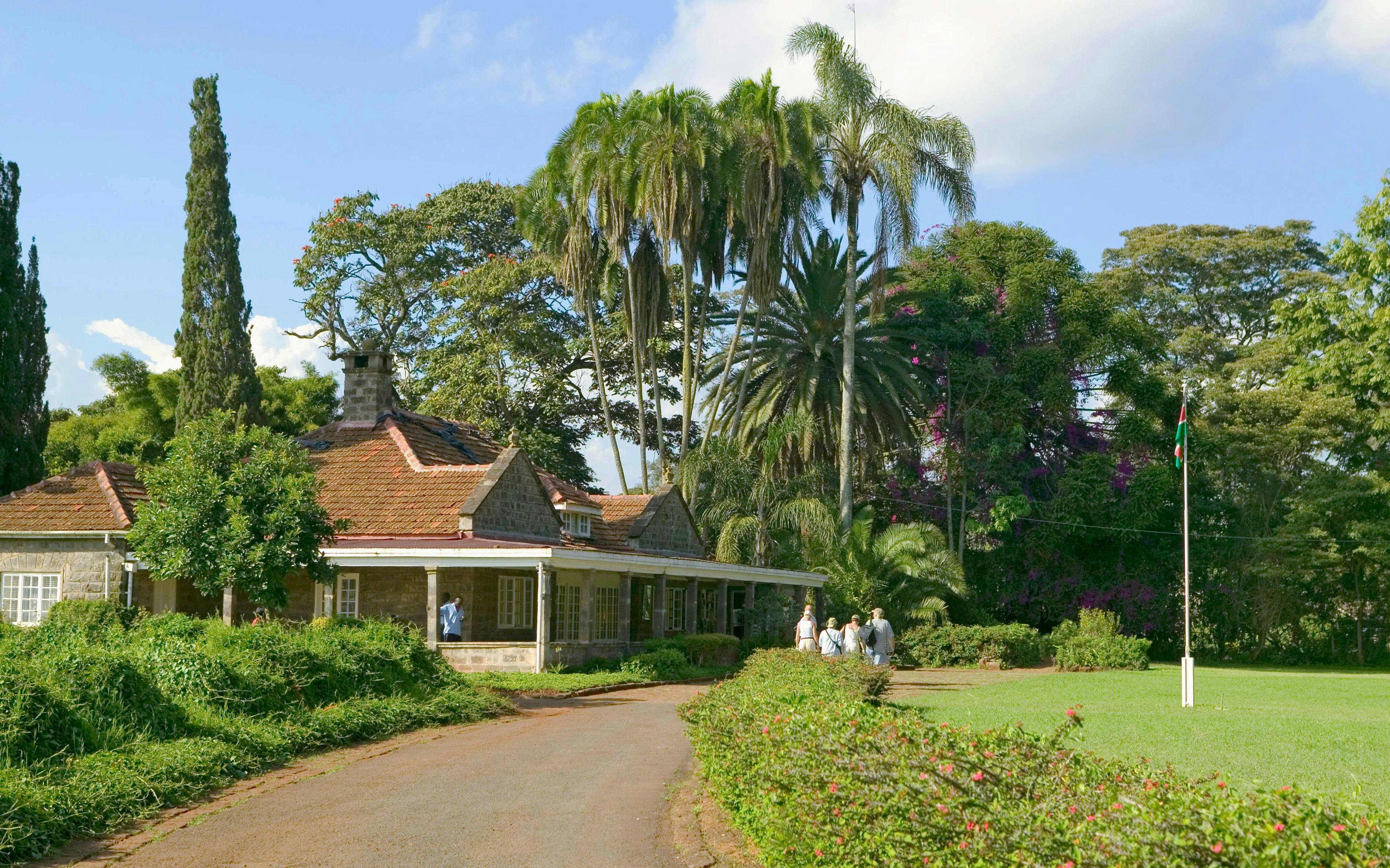 Karen Blixen Museum with visitors in lush garden, Nairobi, Kenya.