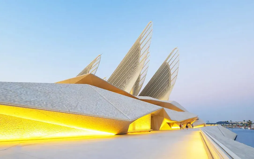 Zayed National Museum exterior with illuminated architecture, Abu Dhabi.