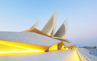Zayed National Museum exterior with illuminated architecture, Abu Dhabi.