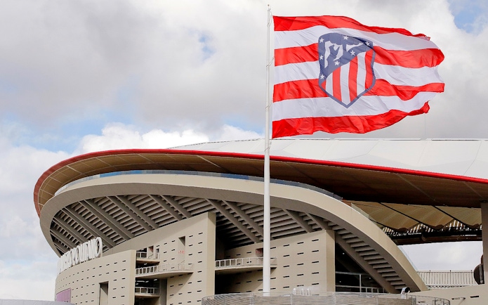 Cívitas Metropolitano stadium exterior with Atlético Madrid flag.