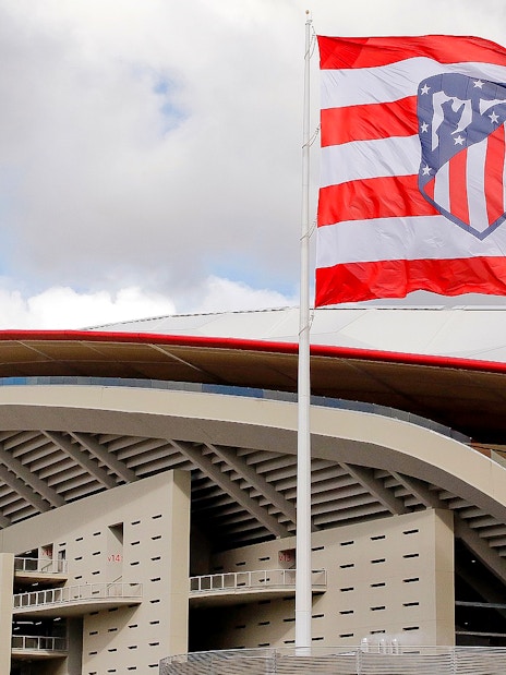 Cívitas Metropolitano stadium exterior with Atlético Madrid flag.