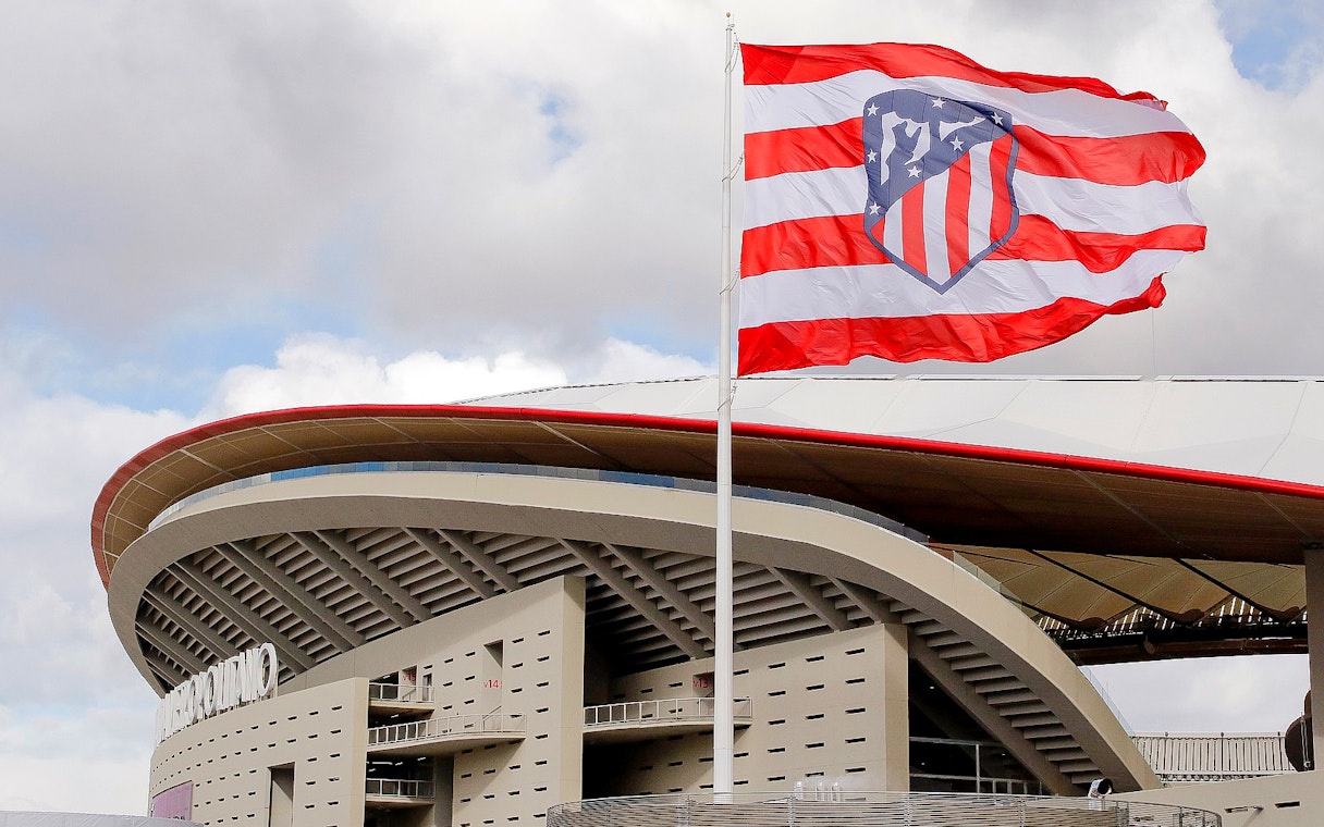 Cívitas Metropolitano stadium exterior with Atlético Madrid flag.