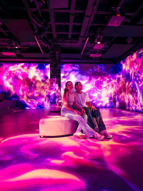 Tourists enjoying immersive AV room at Barcelona Aquarium.