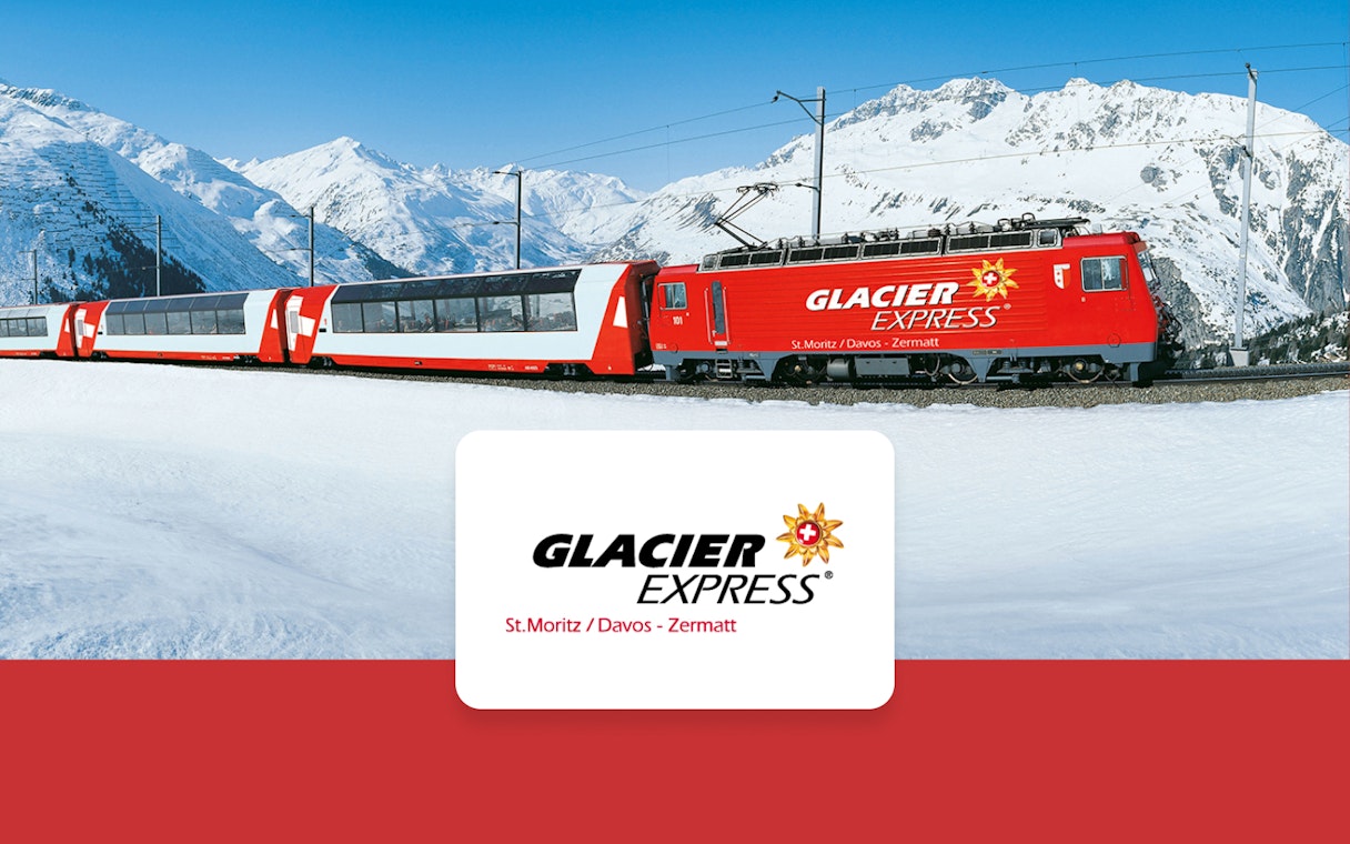 Glacier Express train traveling through snowy Swiss Alps between Zermatt and St. Moritz.