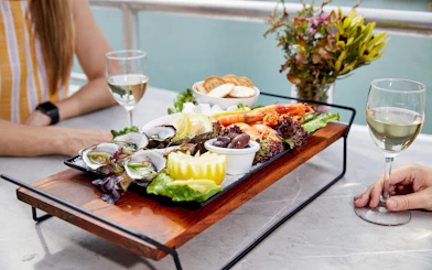 Seafood platter with oysters and prawns on Darwin Harbour lunch cruise table.