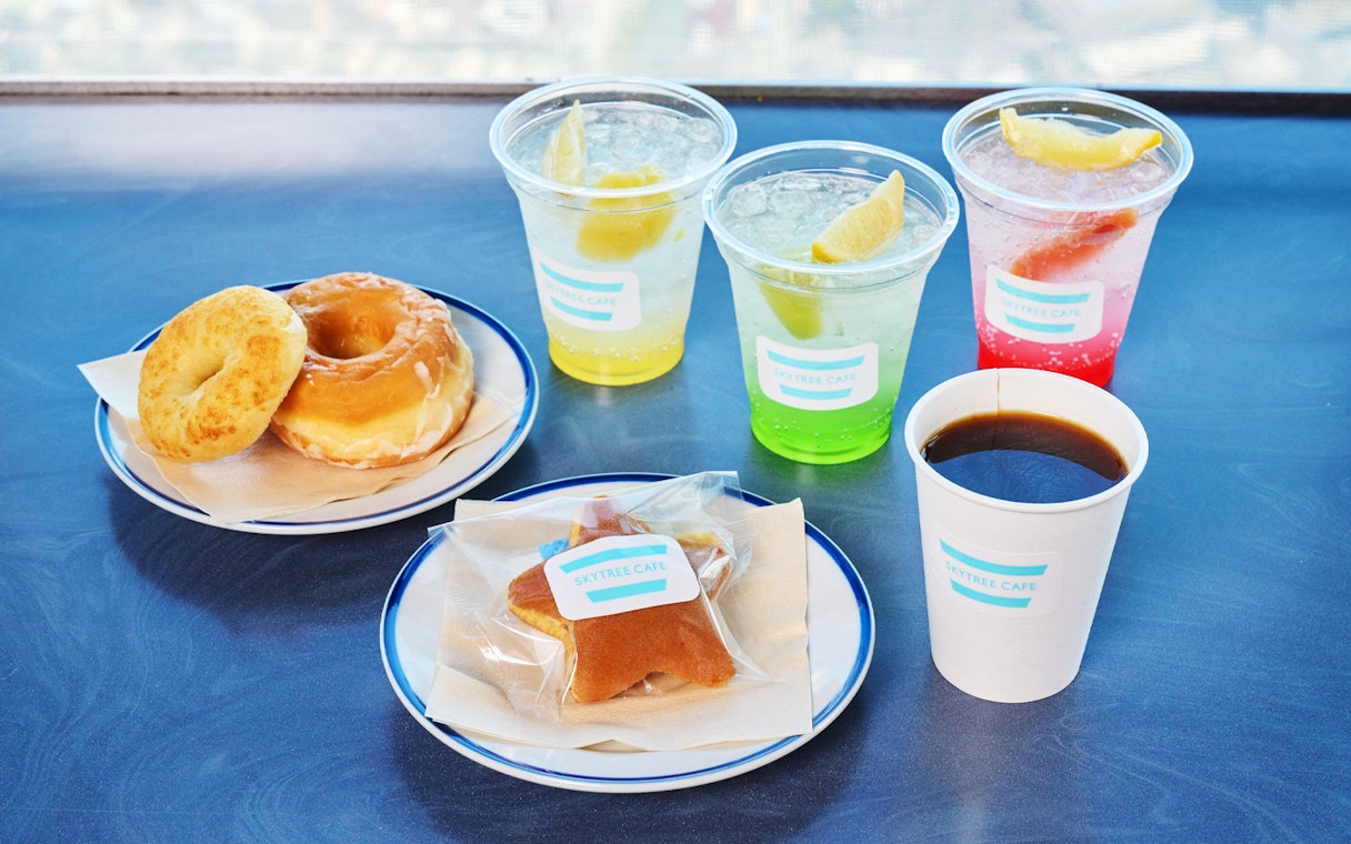 Soft drinks and snacks platter at Tokyo Skytree Cafe with donuts and coffee.