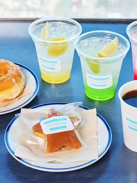 Soft drinks and snacks platter at Tokyo Skytree Cafe with donuts and coffee.