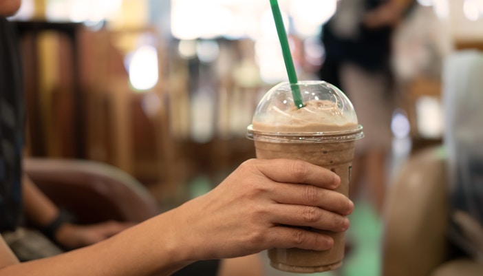 A barista handing over a coffee