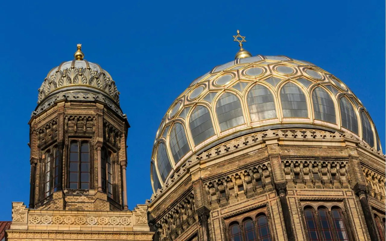 Berlin New Synagogue domes against blue sky, part of Jewish District exploration game.