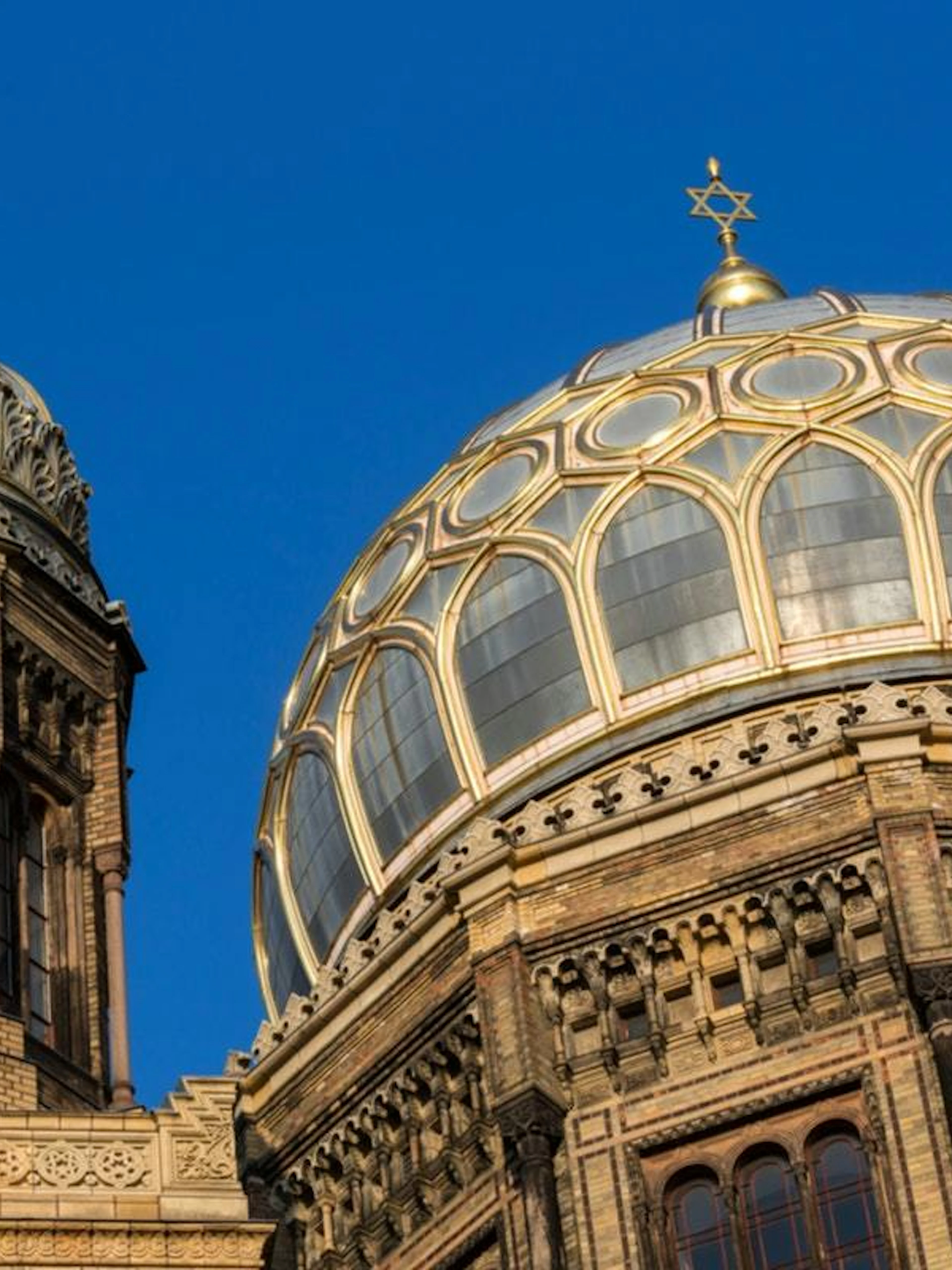 Berlin New Synagogue domes against blue sky, part of Jewish District exploration game.
