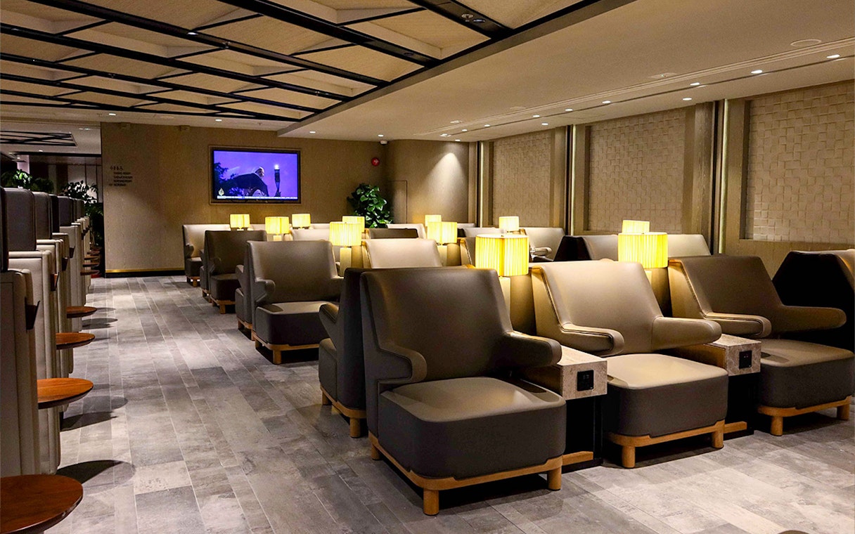 Plaza Premium Lounge seating area with armchairs and lamps.