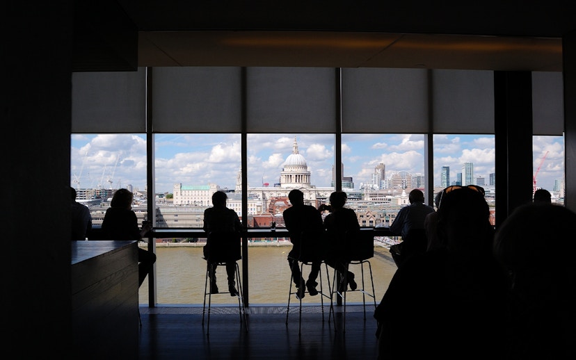People enjoying the London skyline view from Tate Modern, featuring St. Paul's Cathedral.