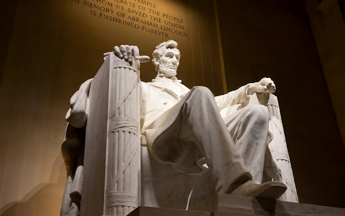 Lincoln Memorial statue illuminated at night during Washington DC moonlight bus tour.