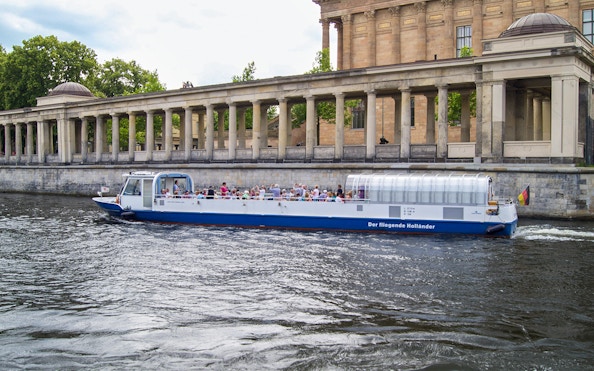 Berlin dinner cruise boat passing Museum Island's colonnade.
