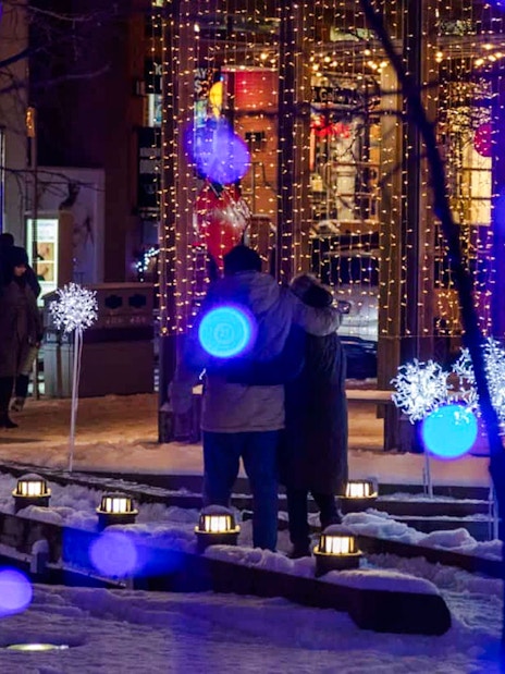 Festive light installation with blue and white lights in snowy Toronto.