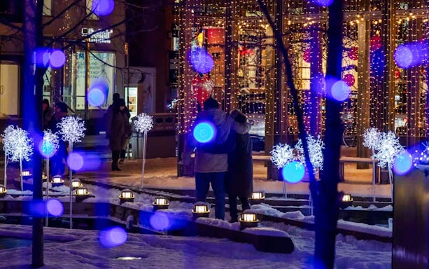 Festive light installation with blue and white lights in snowy Toronto.