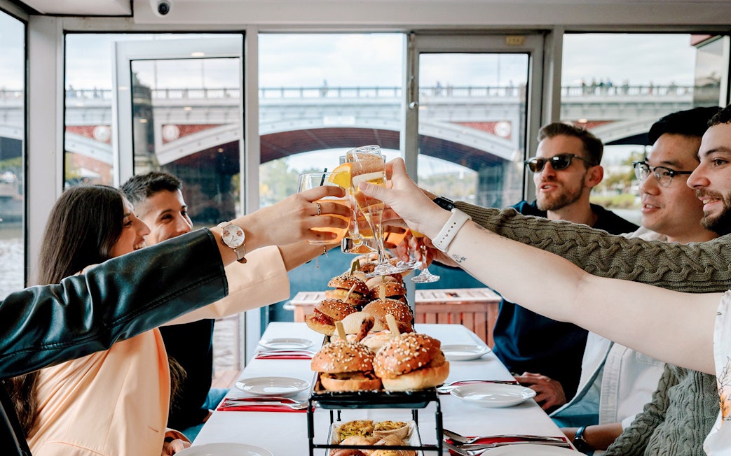 Dining guests toasting with drinks on the Spirit of Melbourne Cruising Restaurant.