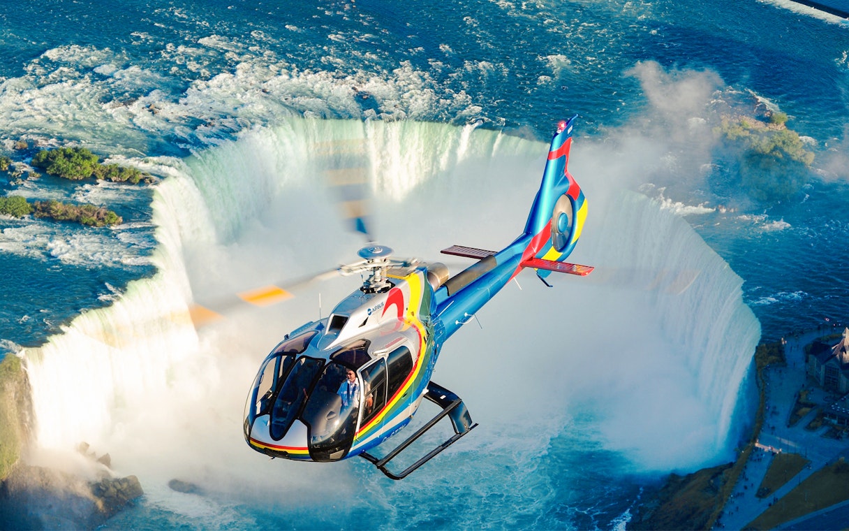 Helicopter over Niagara Falls, aerial view of waterfalls, Canada.