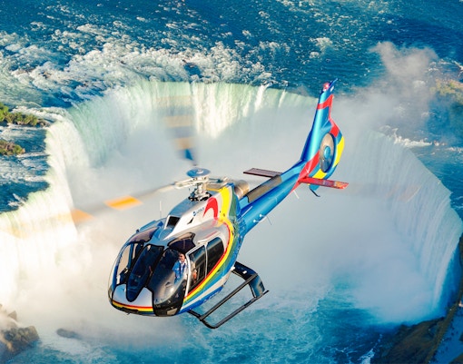 Helicopter over Niagara Falls, aerial view of waterfalls, Canada.