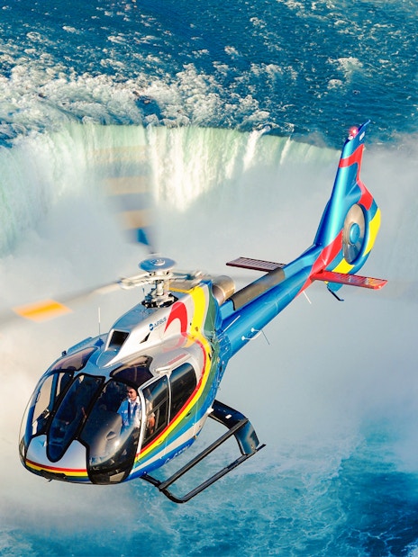 Helicopter over Niagara Falls, aerial view of waterfalls, Canada.