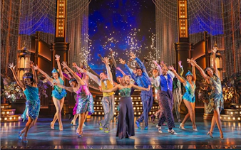 Performers dancing on stage in The Great Gatsby musical on Broadway.