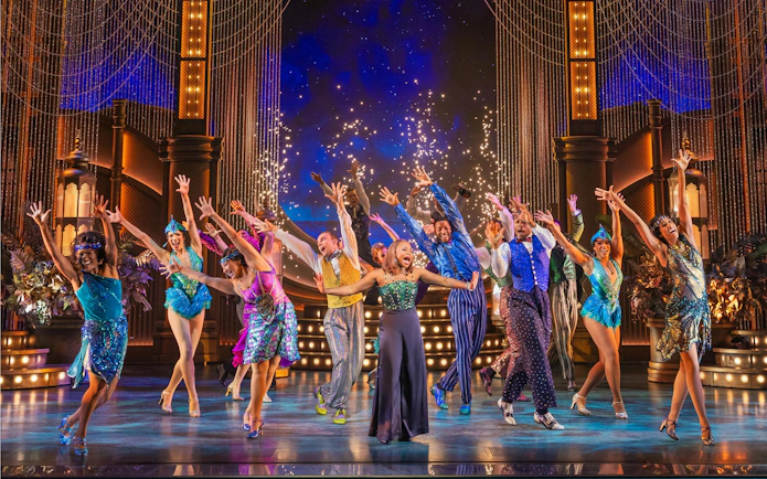 Performers dancing on stage in The Great Gatsby musical on Broadway.