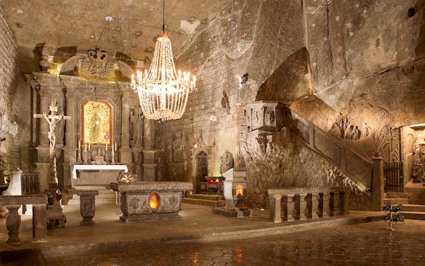 Chapel with altar and chandelier in Wieliczka Salt Mine chamber, Poland.