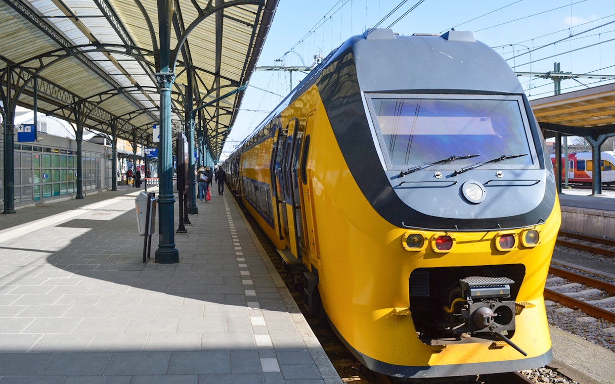Train at platform for NS transfer between Schiphol Airport and Amsterdam.