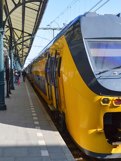 Train at platform for NS transfer between Schiphol Airport and Amsterdam.