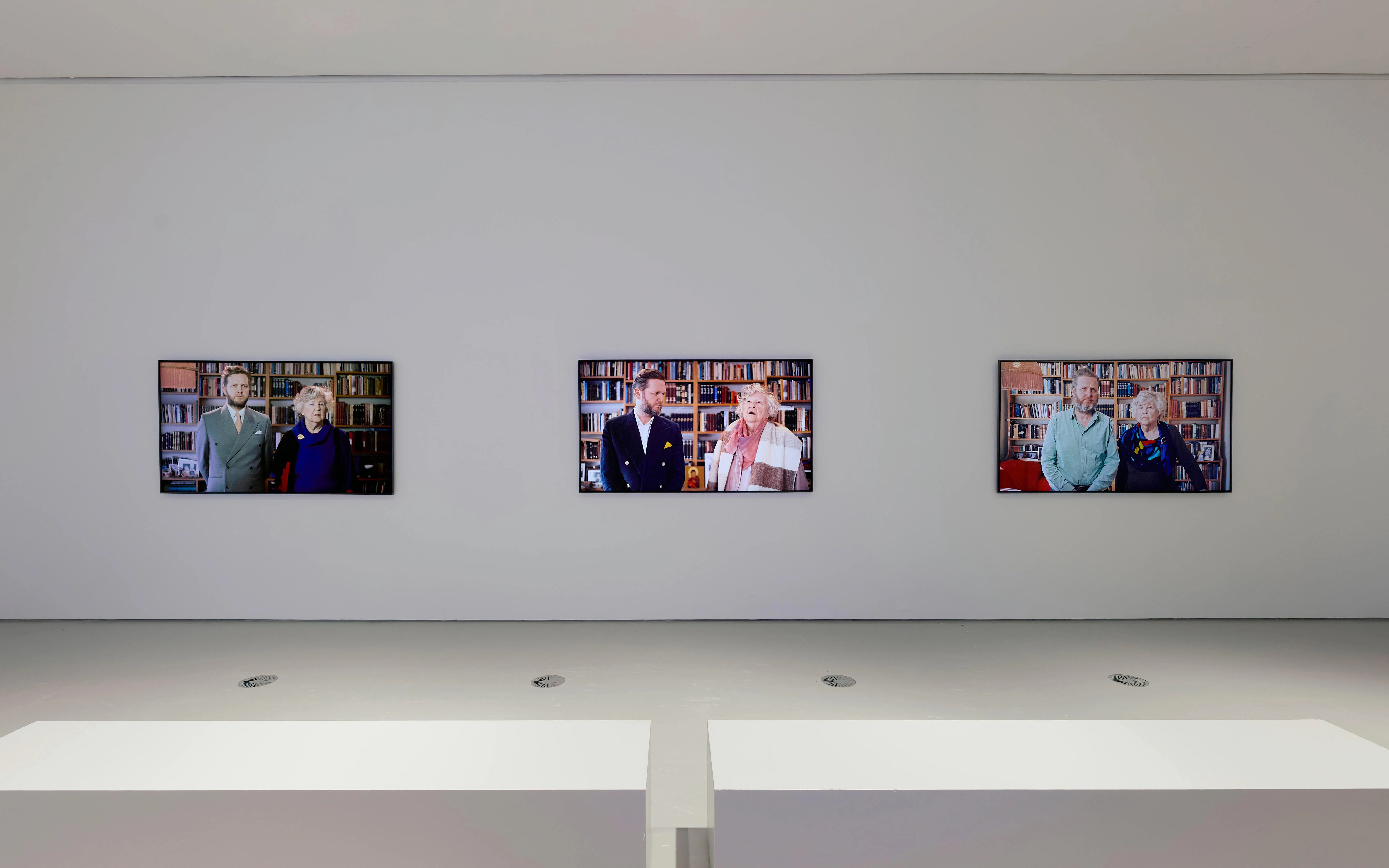Three video screens displaying portraits at Ragnar Kjartansson: Mercy Exhibition, National Gallery of Victoria.