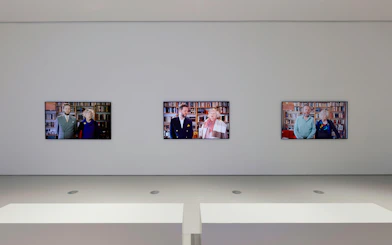 Three video screens displaying portraits at Ragnar Kjartansson: Mercy Exhibition, National Gallery of Victoria.