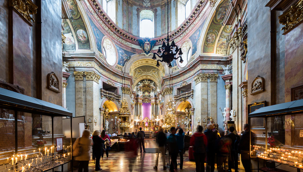 St. Peter's Church interior with visitors and lit candles during Christmas concert.