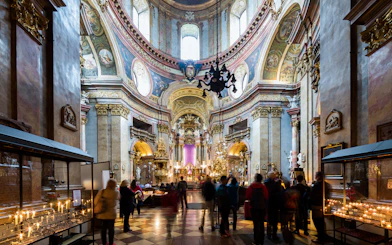 St. Peter's Church interior with visitors and lit candles during Christmas concert.